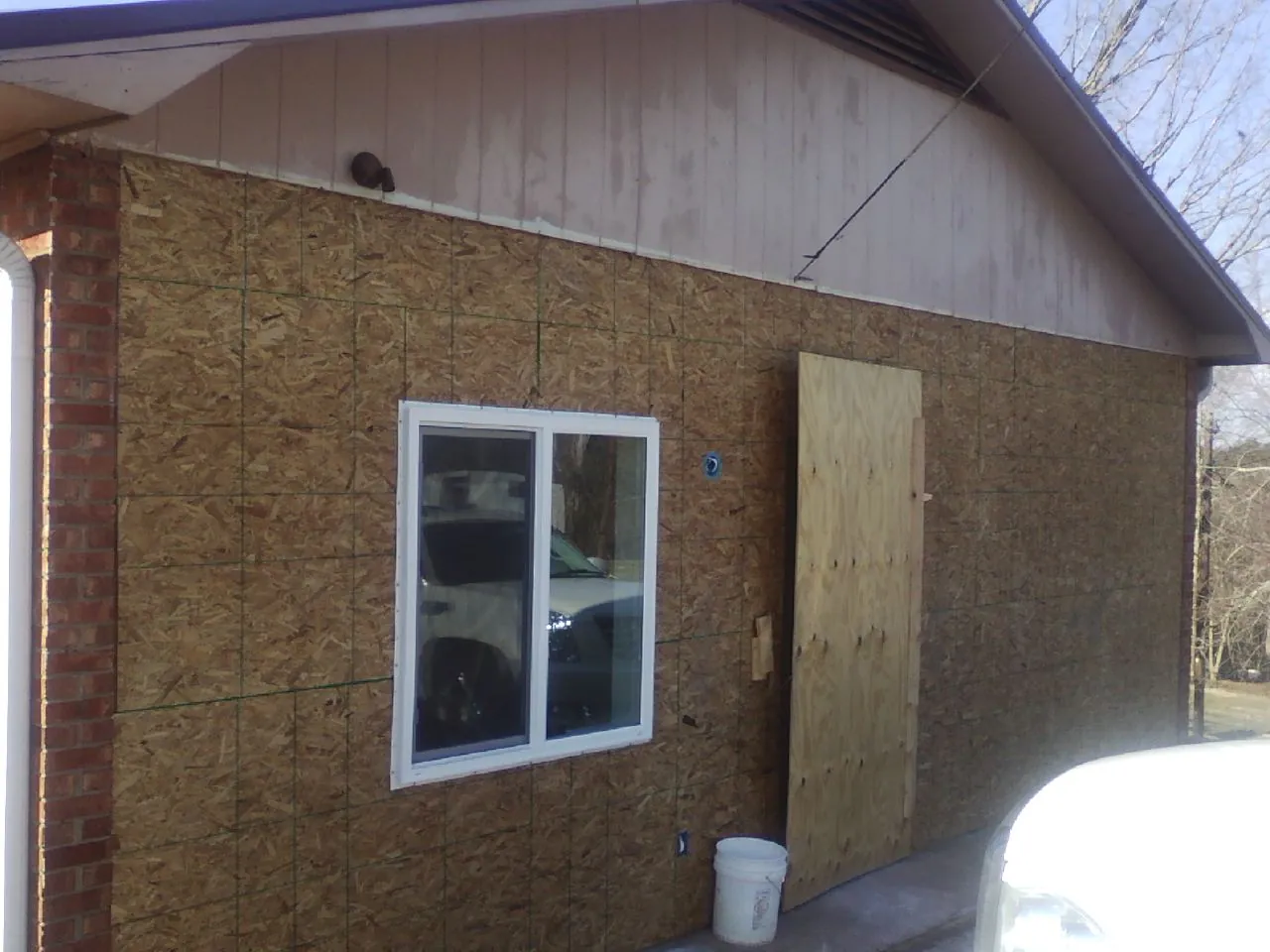 OSB sheathing on a garage addition wall before siding in Beaver Springs